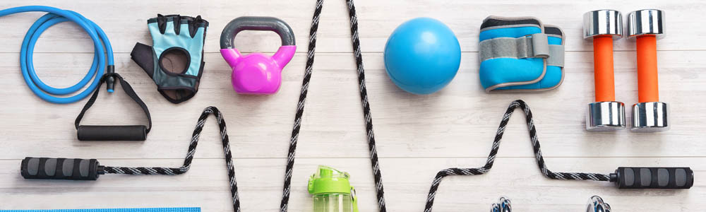 Various pieces of equipment, including resistance band, TRX, gloves, kettlebell, skipping rope, weights, balls, and more